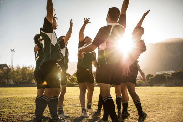 A men's sports team celebrates a victory